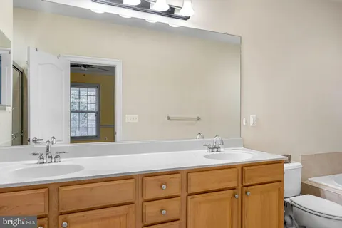 a bedroom with a bed and a potted plant