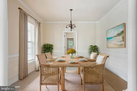 a view of a hallway with wooden floor and a living room