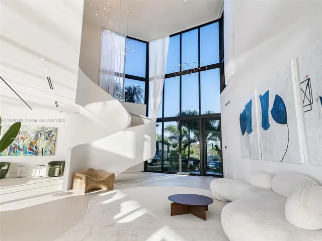 a living room with patio furniture and a potted plant