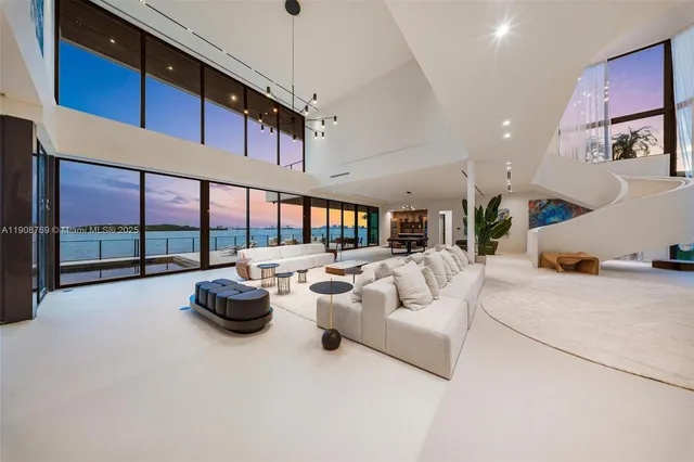 a living room with lots of furniture and a chandelier