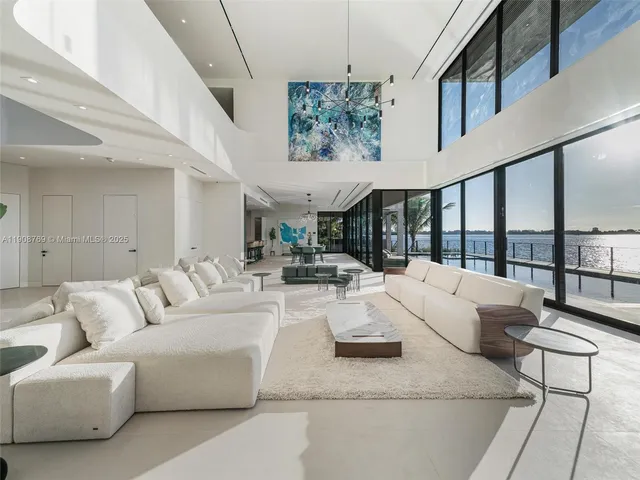 a living room with furniture and a floor to ceiling window