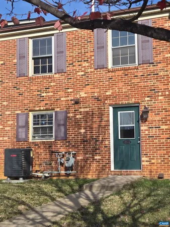 a view of a brick house with many windows