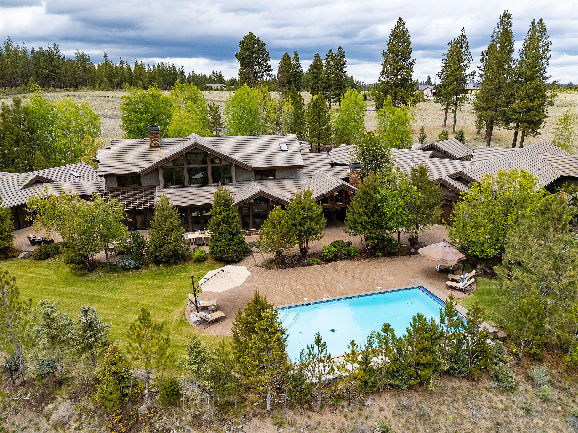 18883 Sutherland Court Bend, OR 97702 - Photo 61 of 70 A serene composition of water, stone, and architecture?pool views framed by both homes.