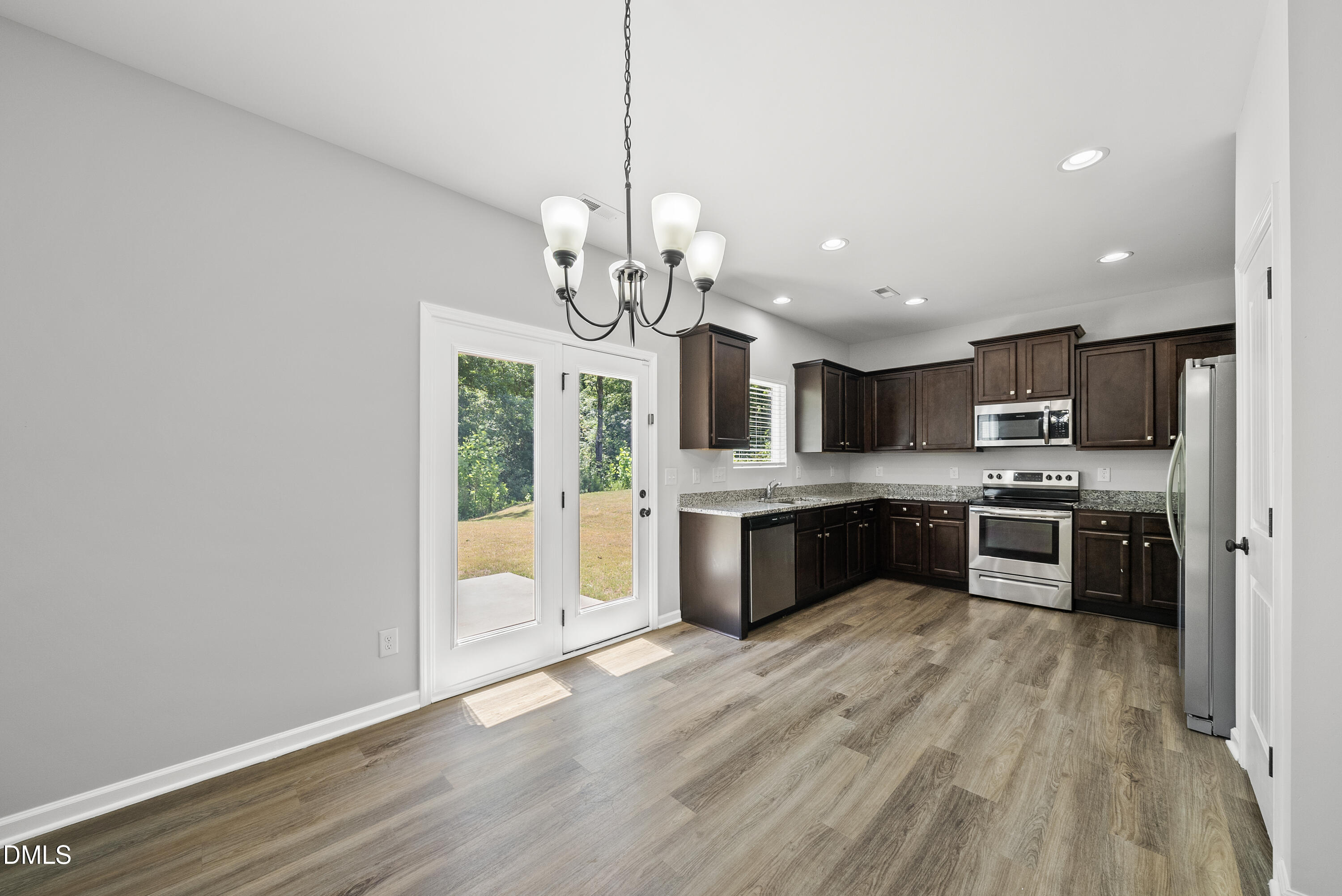 2816 Elsa Drive Raleigh, NC 27610 - Photo 15 of 35 a large kitchen with stainless steel appliances granite countertop a lot of counter space cabinets and wooden floor