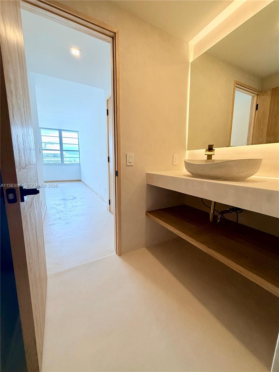 100 Lincoln Road, Unit 1241 Miami Beach, FL 33139 - Photo 13 of 18 a bathroom with a sink a double vanity and a mirror