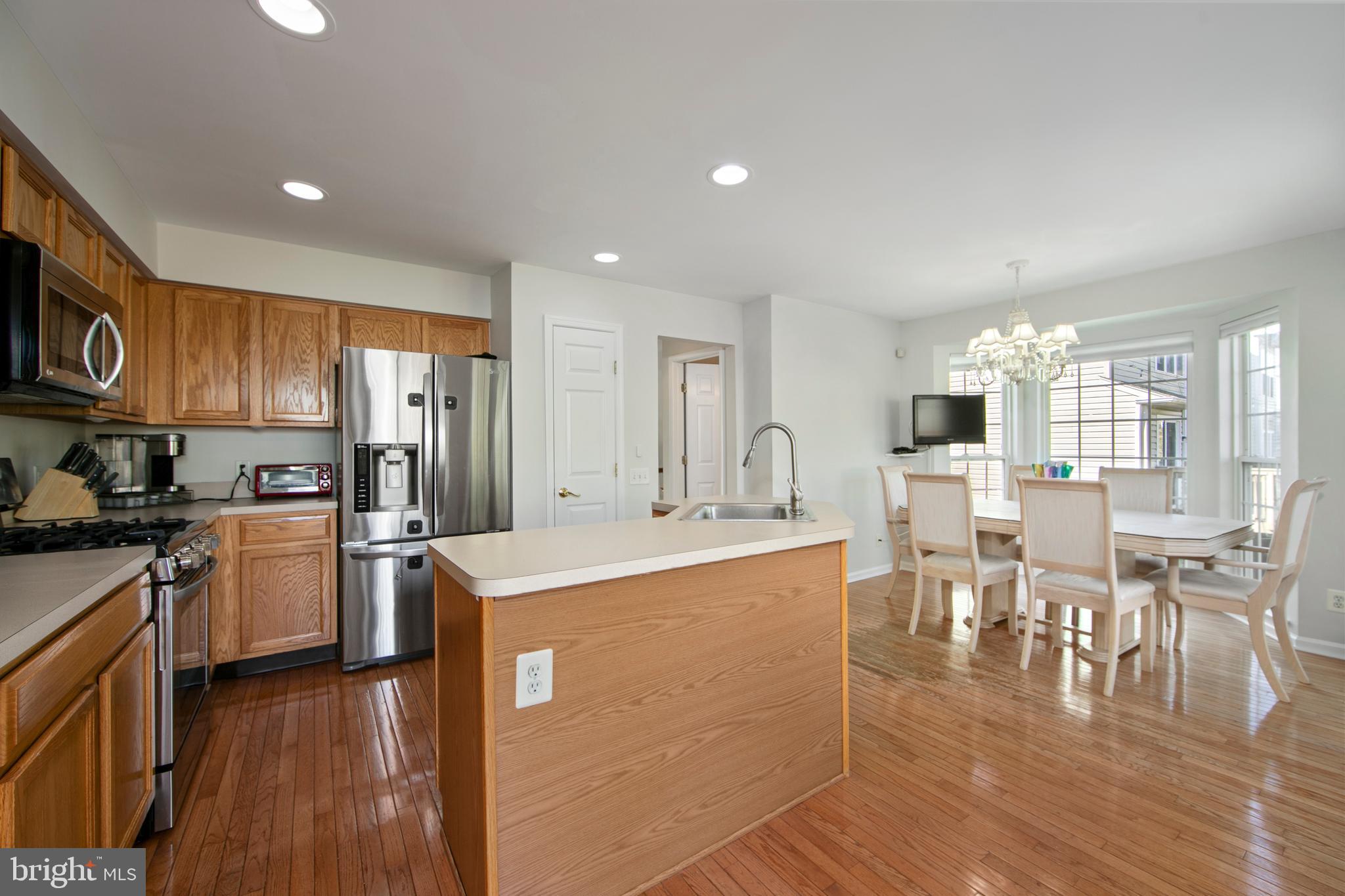 27 Firethorn Lane Riverside, NJ 08075 - Photo 19 of 43 a large kitchen with cabinets chairs and wooden floor
