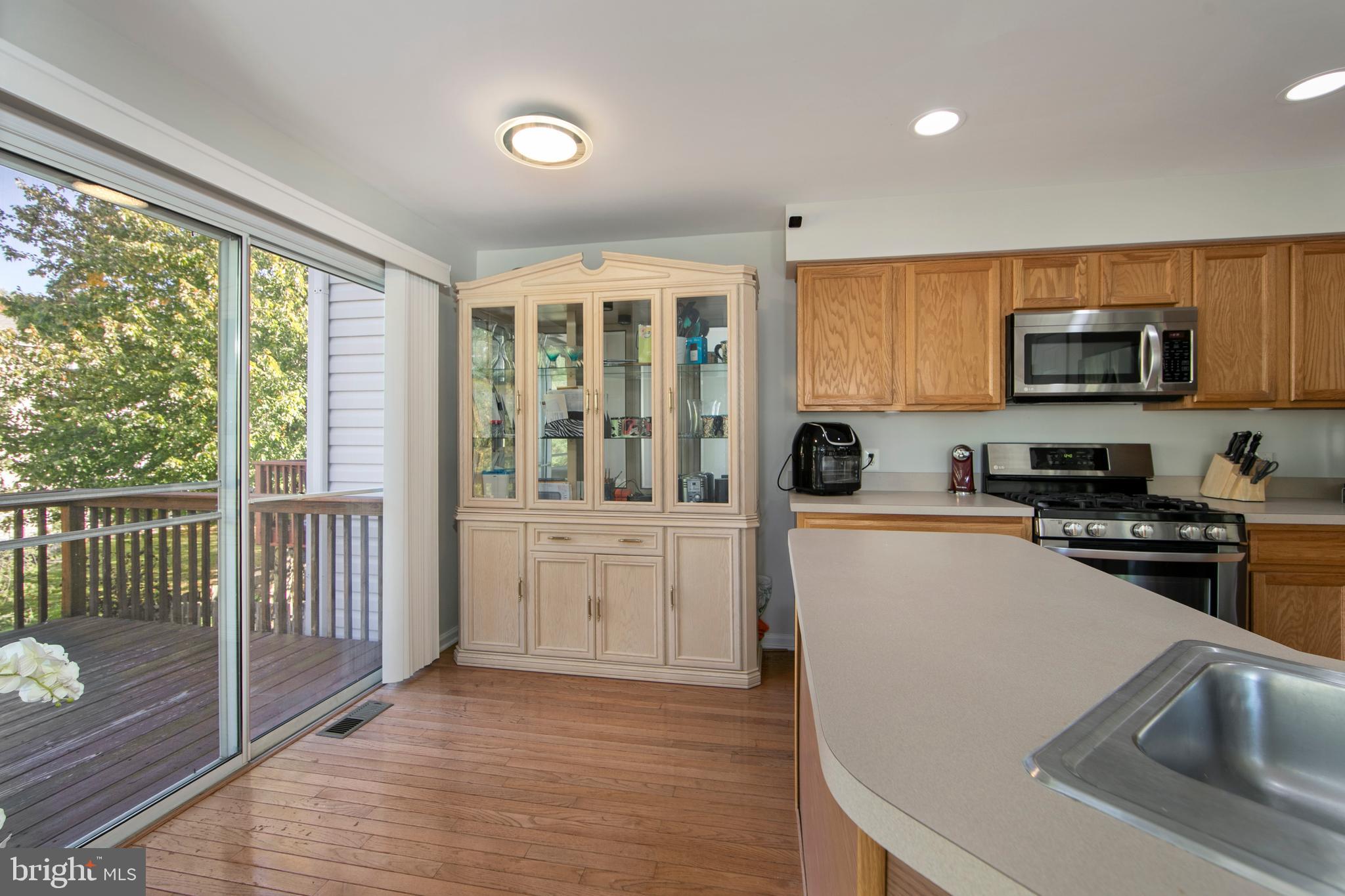 27 Firethorn Lane Riverside, NJ 08075 - Photo 20 of 43 a kitchen with granite countertop a stove a sink and a microwave