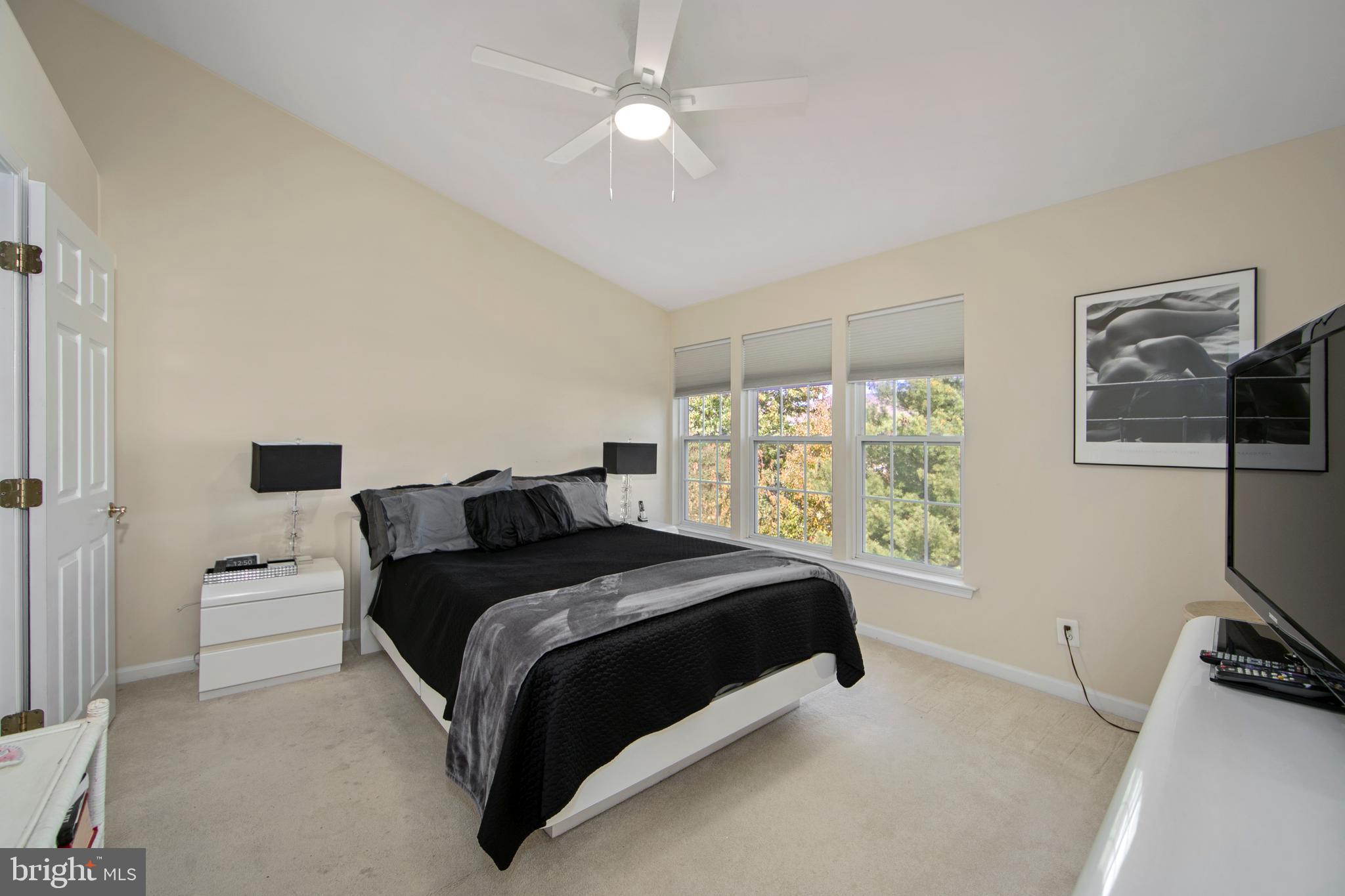 27 Firethorn Lane Riverside, NJ 08075 - Photo 22 of 43 a bedroom with a bed flat screen tv and a large window