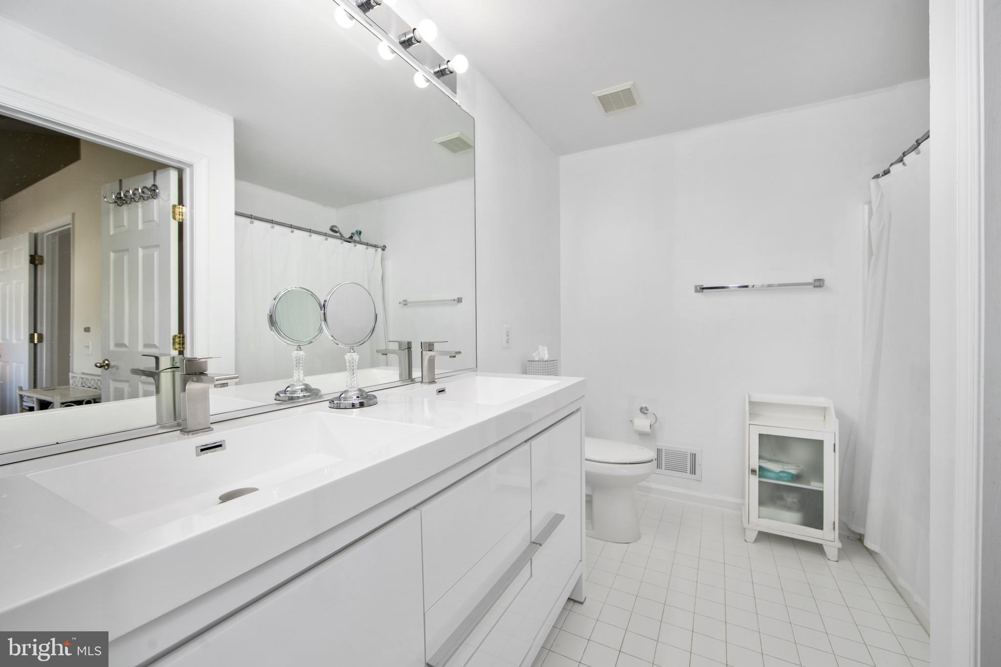 27 Firethorn Lane Riverside, NJ 08075 - Photo 24 of 43 a bathroom with a double vanity sink a toilet and a mirror