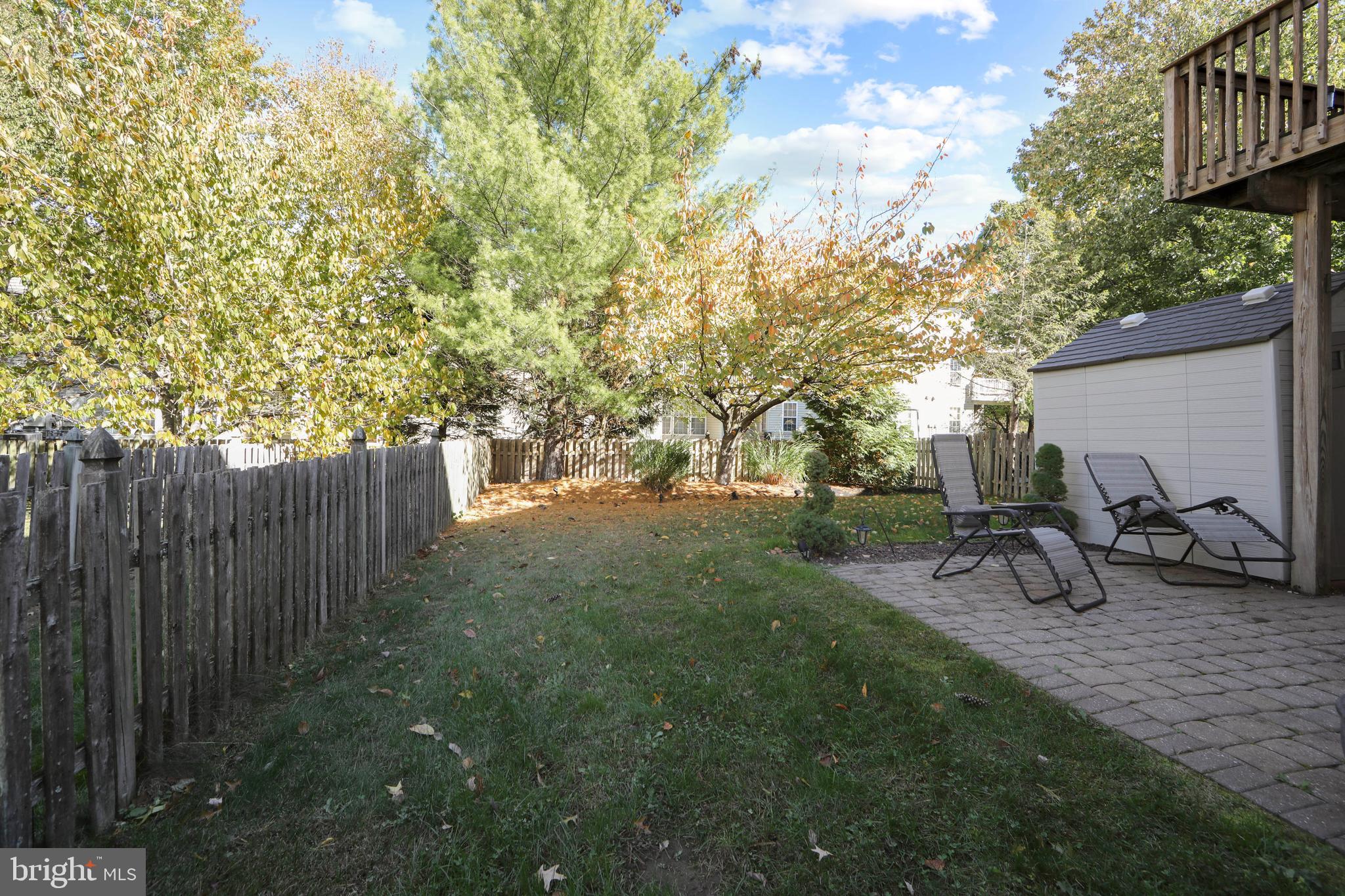 27 Firethorn Lane Riverside, NJ 08075 - Photo 39 of 43 a view of a backyard with wooden fence and a bench