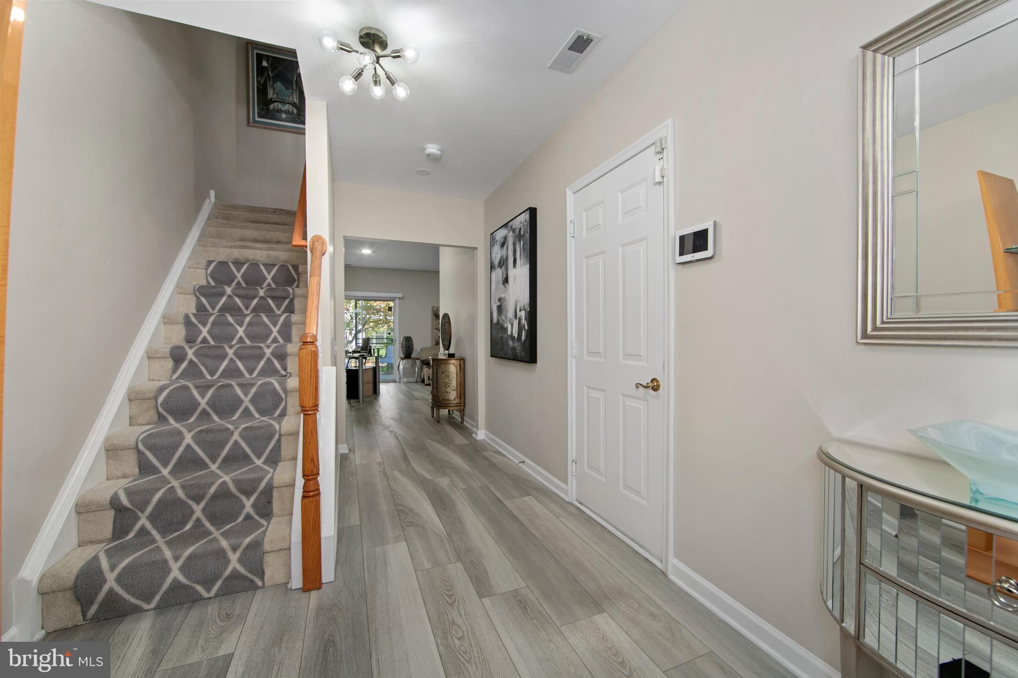 27 Firethorn Lane Riverside, NJ 08075 - Photo 5 of 43 a view of a hallway with wooden floor and staircase