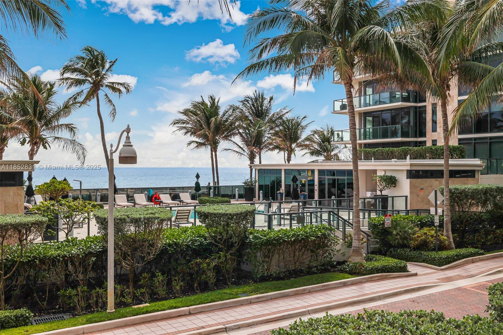 2101 South Surf Road, Unit 2F Hollywood, FL 33019 - Photo 29 of 70 a front view of multi story residential apartment building with a yard and potted plants