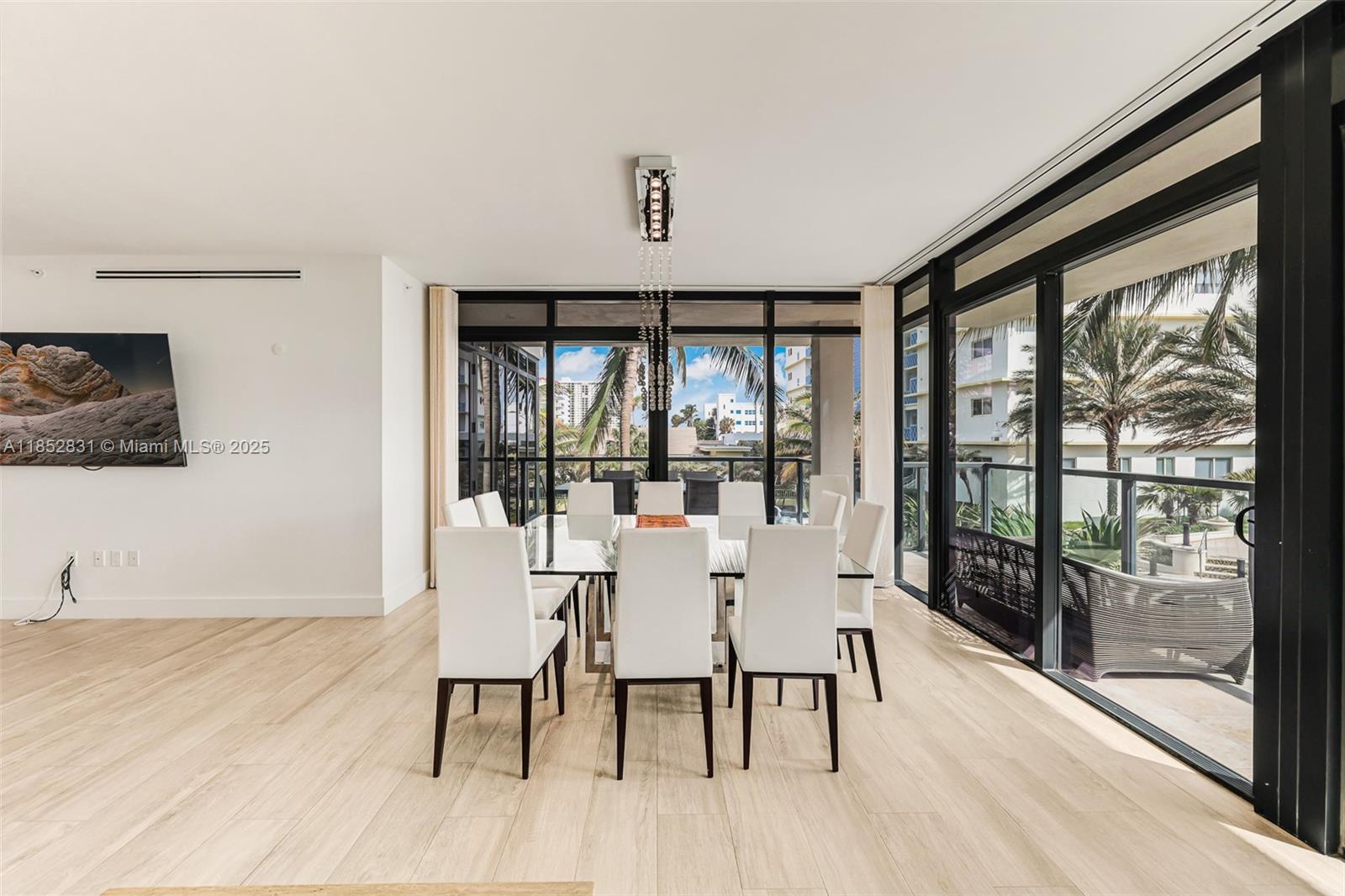 2101 South Surf Road, Unit 2F Hollywood, FL 33019 - Photo 42 of 70 a view of a dining room with furniture large windows and wooden floor