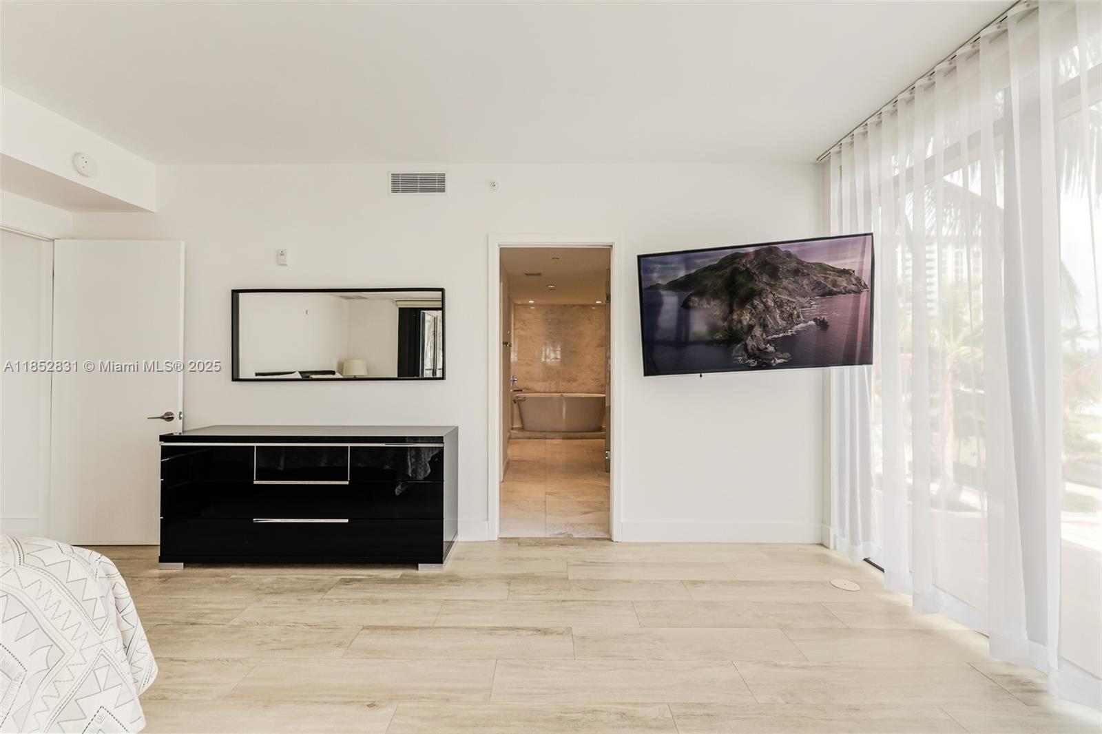 2101 South Surf Road, Unit 2F Hollywood, FL 33019 - Photo 55 of 70 a living room with a fireplace and a flat screen tv