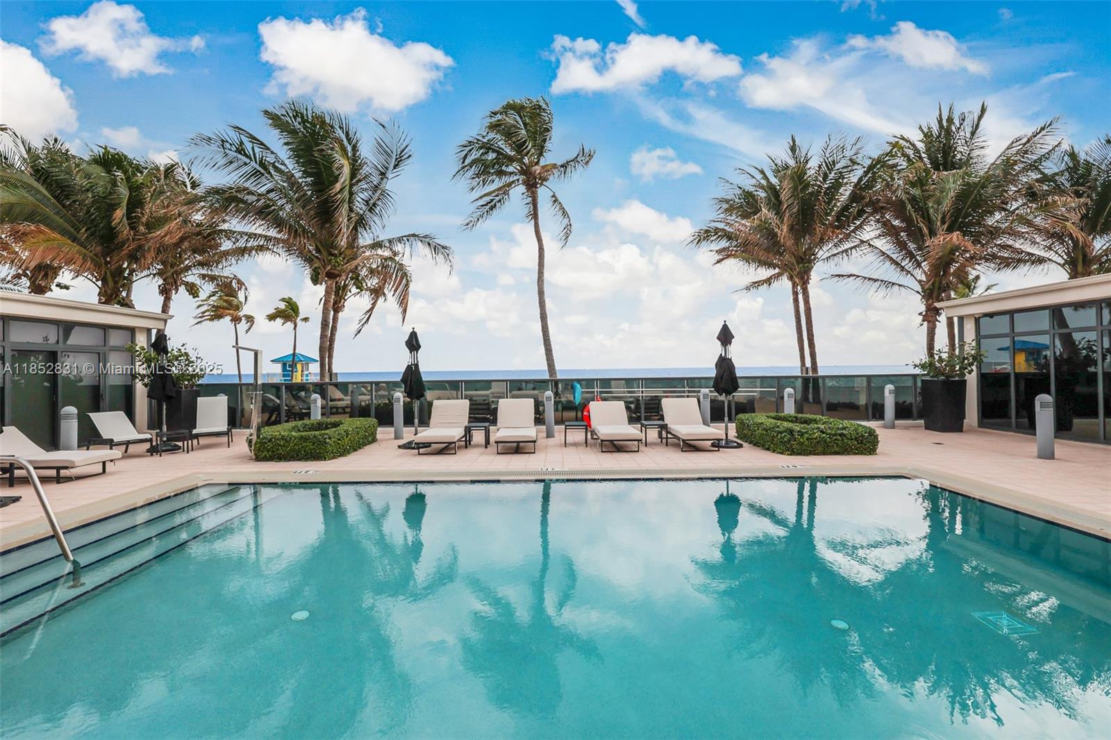 2101 South Surf Road, Unit 2F Hollywood, FL 33019 - Photo 10 of 70 a view of a swimming pool with a patio and palm trees