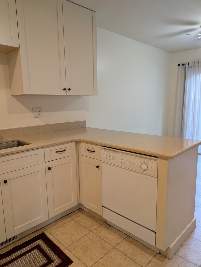 1535 Wedgefield Circle, Unit 1535 Naperville, IL 60563 - Photo 12 of 46 a kitchen with white cabinets and white appliances