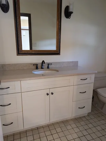 a bathroom with a sink vanity and mirror