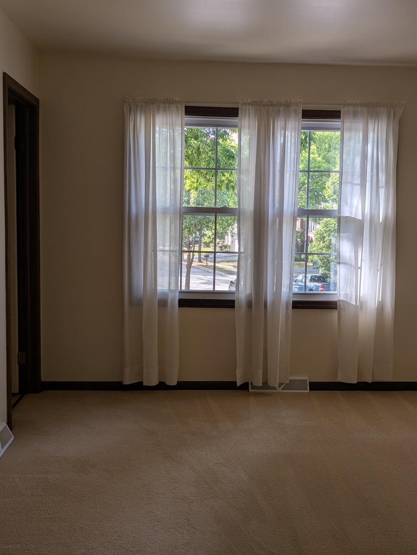 1535 Wedgefield Circle, Unit 1535 Naperville, IL 60563 - Photo 22 of 46 a view of an empty room with large windows