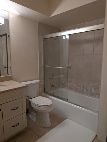 a bathroom with a shower a toilet and a sink