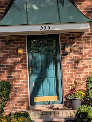 a front view of a building with a garden