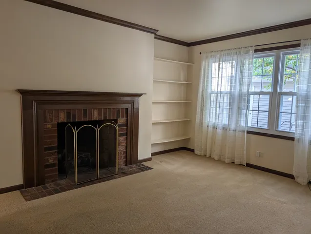 a view of an empty room with a fireplace