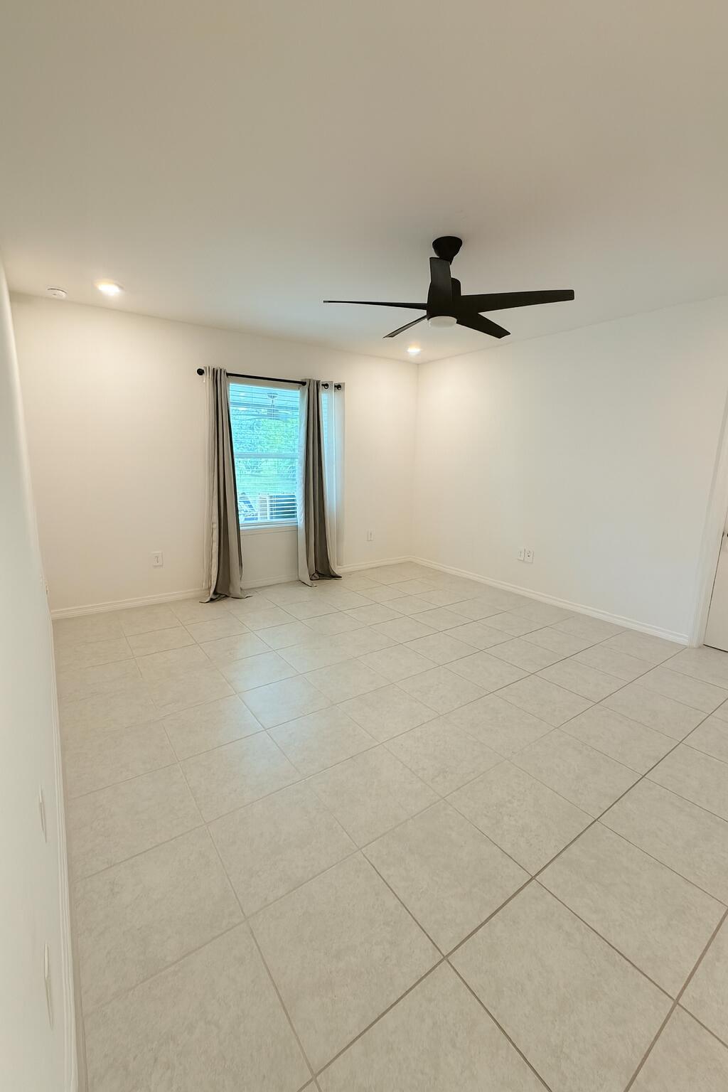 1963 Southwest Import Drive Port St. Lucie, FL 34953 - Photo 12 of 39 an empty room with windows and entrance