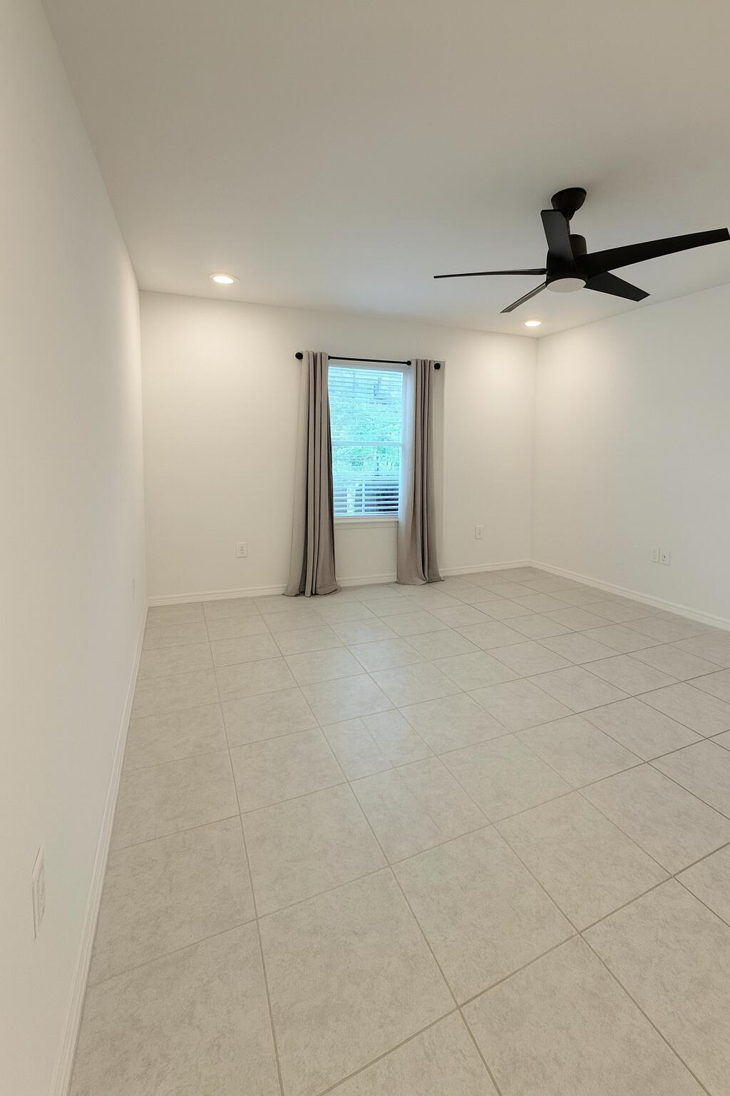 1963 Southwest Import Drive Port St. Lucie, FL 34953 - Photo 13 of 39 an empty room with windows and fan