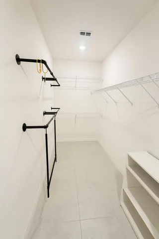 a view of storage and utility room with racks on the wall