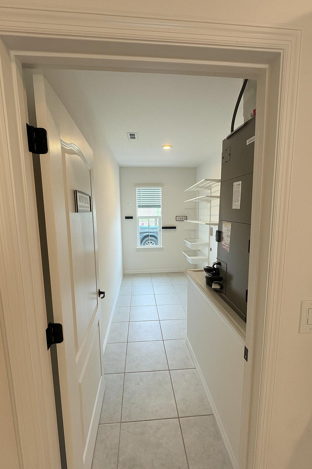 1963 Southwest Import Drive Port St. Lucie, FL 34953 - Photo 31 of 39 a kitchen with a sink a refrigerator and cabinets