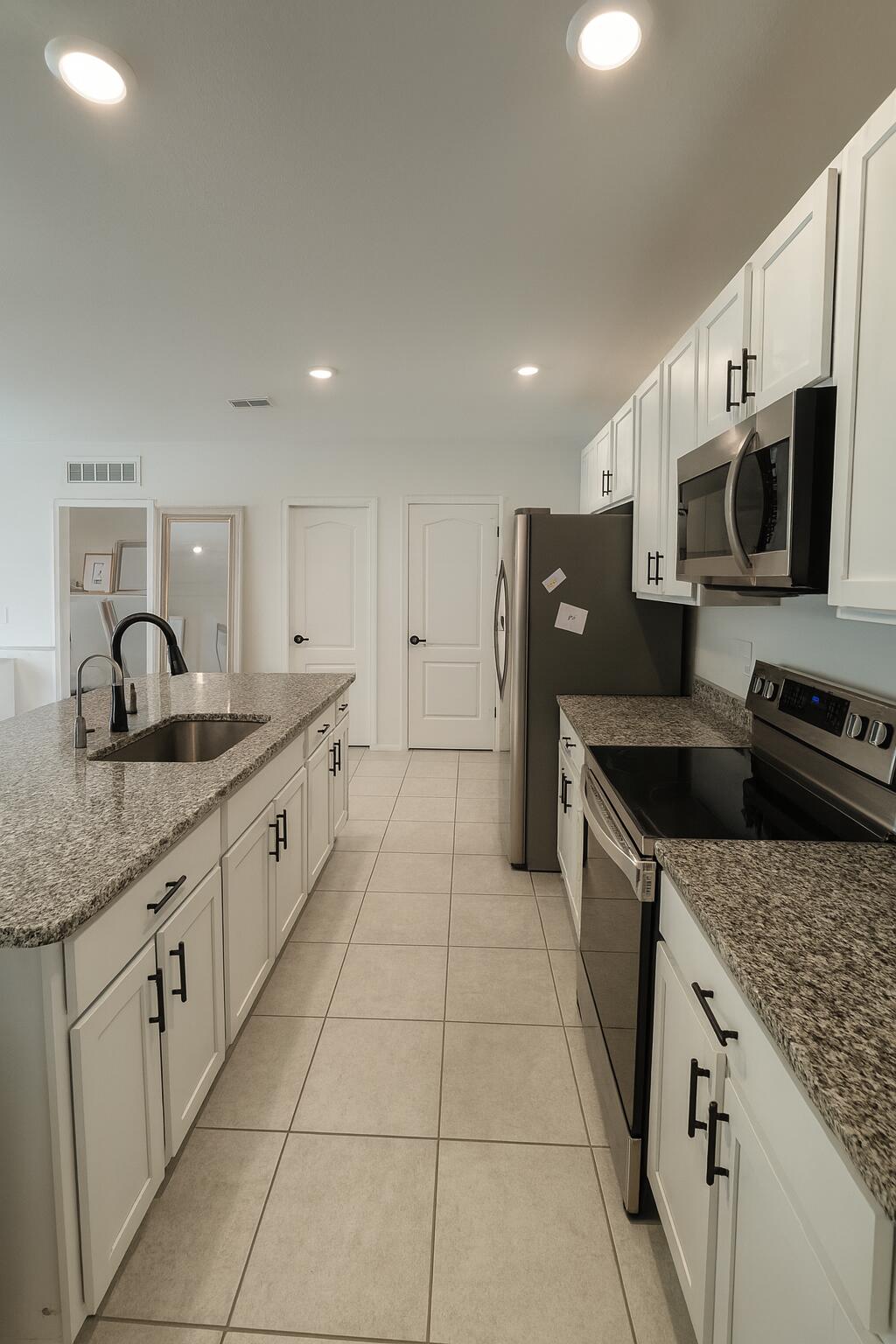 1963 Southwest Import Drive Port St. Lucie, FL 34953 - Photo 5 of 39 a kitchen with stainless steel appliances granite countertop a sink and a stove