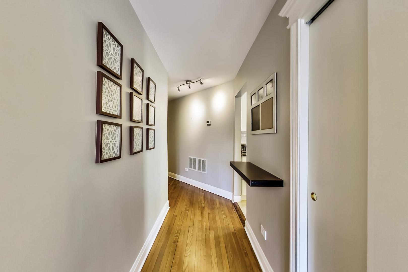4214 North Kenmore Avenue, Unit 2F Chicago, IL 60613 - Photo 13 of 23 a view of a hallway with wooden floor and staircase