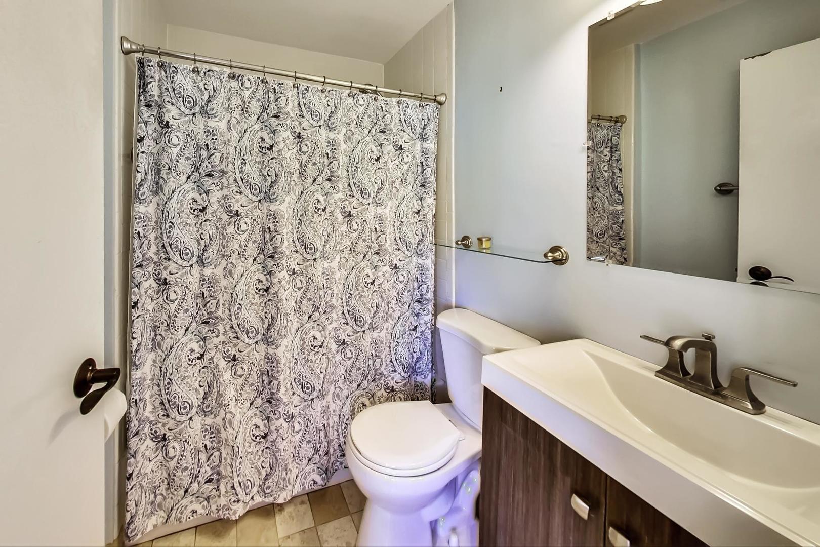 4214 North Kenmore Avenue, Unit 2F Chicago, IL 60613 - Photo 19 of 23 a bathroom with a sink toilet and shower