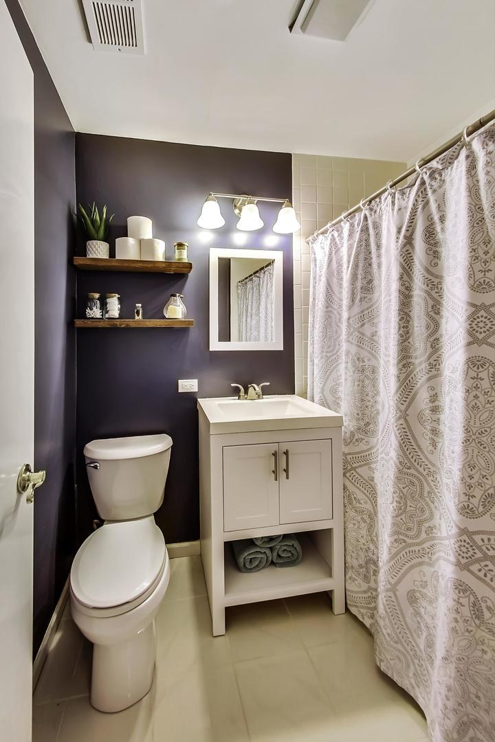 4214 North Kenmore Avenue, Unit 2F Chicago, IL 60613 - Photo 23 of 23 a bathroom with a sink mirror and toilet