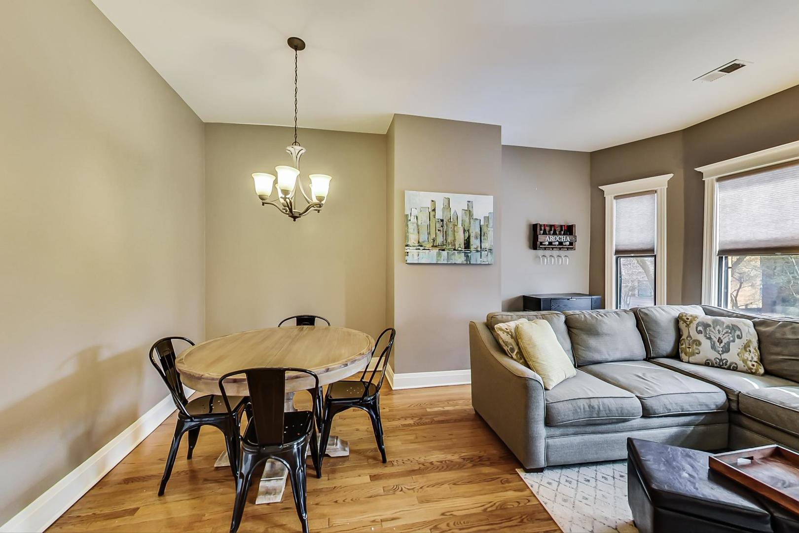 4214 North Kenmore Avenue, Unit 2F Chicago, IL 60613 - Photo 7 of 23 a living room with furniture and a chandelier