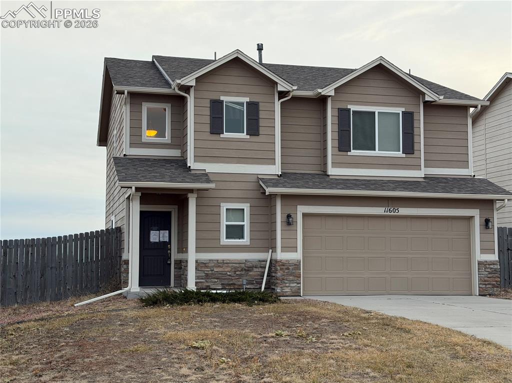 11605 Avena Road Peyton, CO 80831 - Photo 13 of 13 a front view of a house with garage