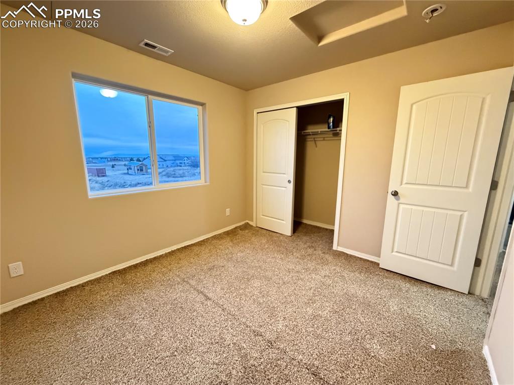 11605 Avena Road Peyton, CO 80831 - Photo 10 of 13 a view of an empty room with a window