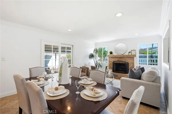 a dining room with furniture a fireplace and wooden floor