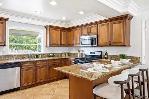 a bathroom with a granite countertop sink a mirror and a bathtub