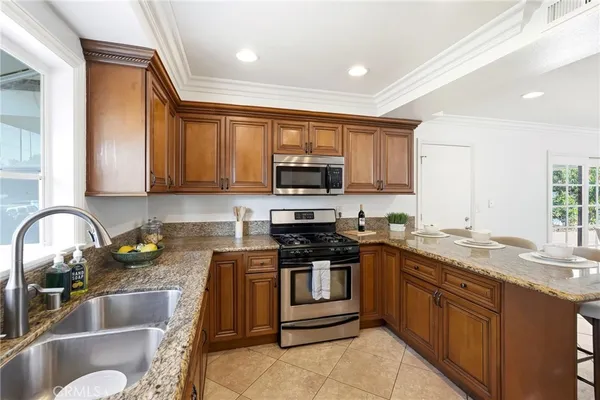 a bathroom with a granite countertop sink a mirror and a