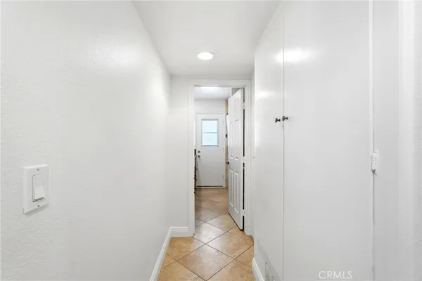 a living room with a bed furniture and a flat screen tv