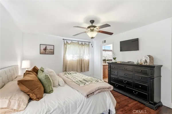 a bedroom with a bed and a potted plant