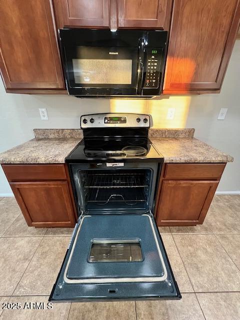 33578 North Sandstone Drive San Tan Valley, AZ 85143 - Photo 18 of 53 a kitchen with wooden cabinets and a stove top oven