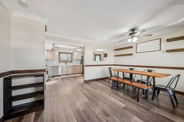 a dining room with furniture and wooden floor