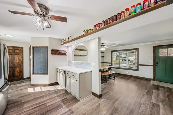 a kitchen view with stainless steel appliances granite countertop a lot of counter space and wooden floor