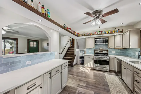 a view of a kitchen with sink and dishwasher wooden floor