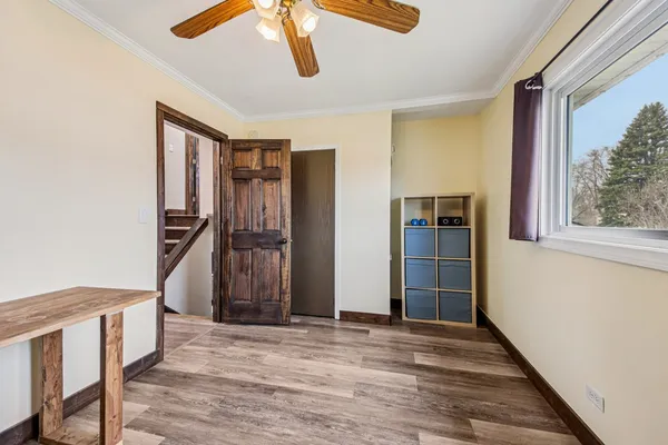 a view of an entryway with wooden floor and stairs