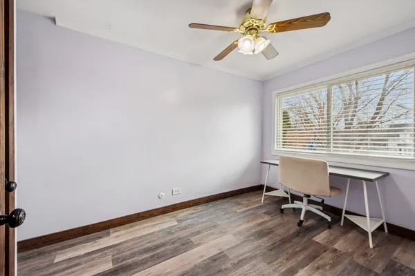 a view of a workspace with furniture and a window