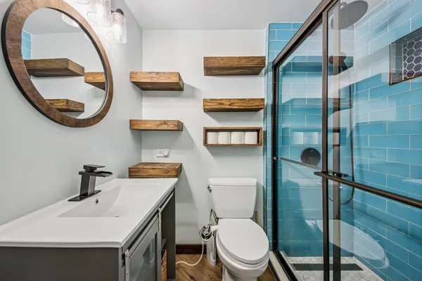 a bathroom with a toilet a sink and a mirror