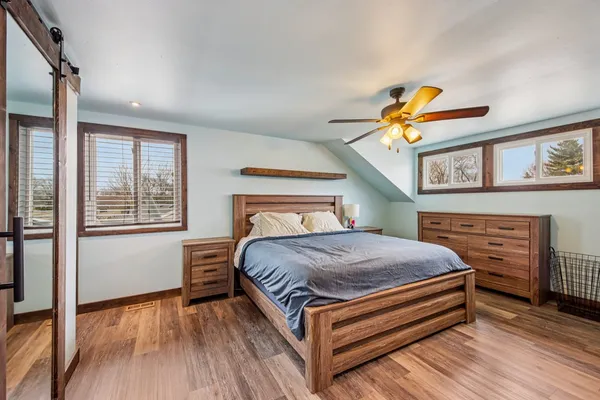 a bed sitting in a bedroom next to a window