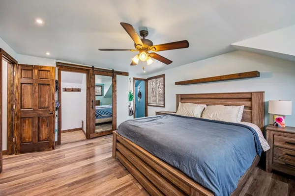 a bedroom with a large bed and a chandelier